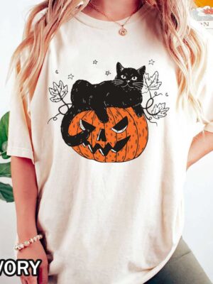 Black Cat Sitting on a Jack-O-Lantern Halloween T-Shirt Black Cat Sitting on a Jack-O-Lantern Halloween T-Shirt