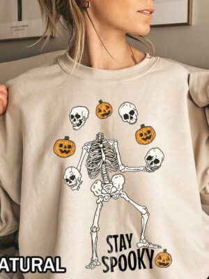 Stay Spooky Sweatshirt featuring a headless skeleton dancing with skulls and jack-o-lanterns